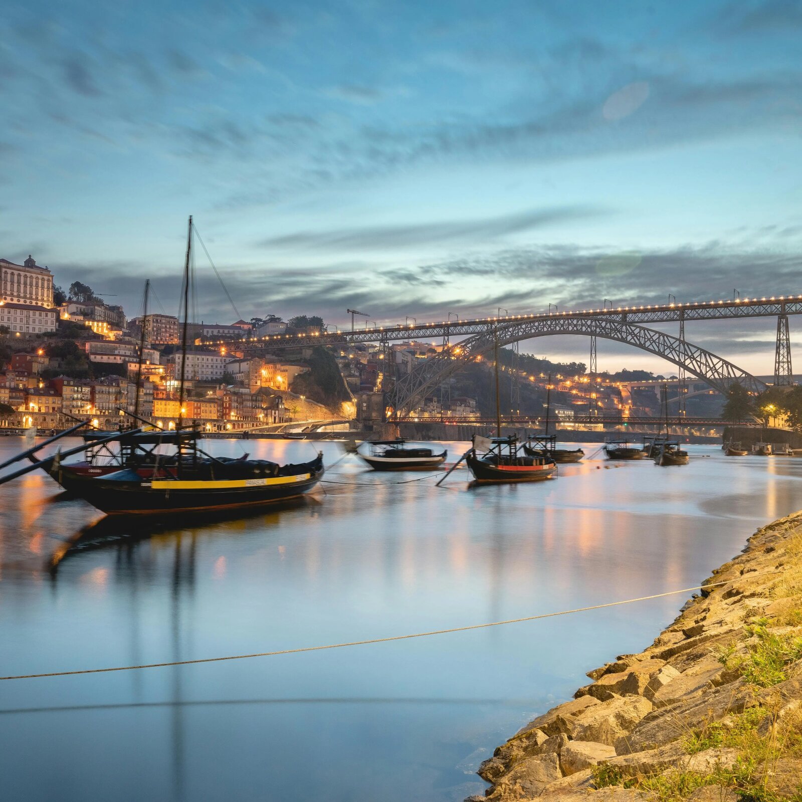 Sailing boat on the Douro at sunset facing the Gaia cellars